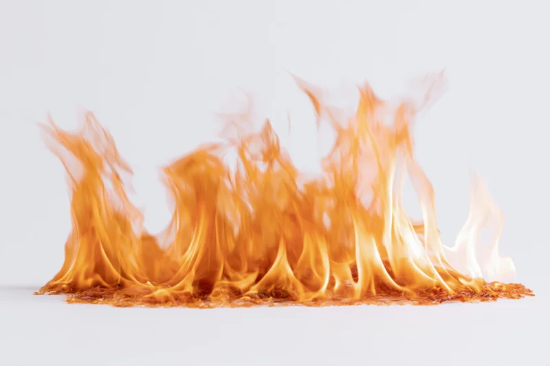 Cluster of open flames burning steadily against a plain white background