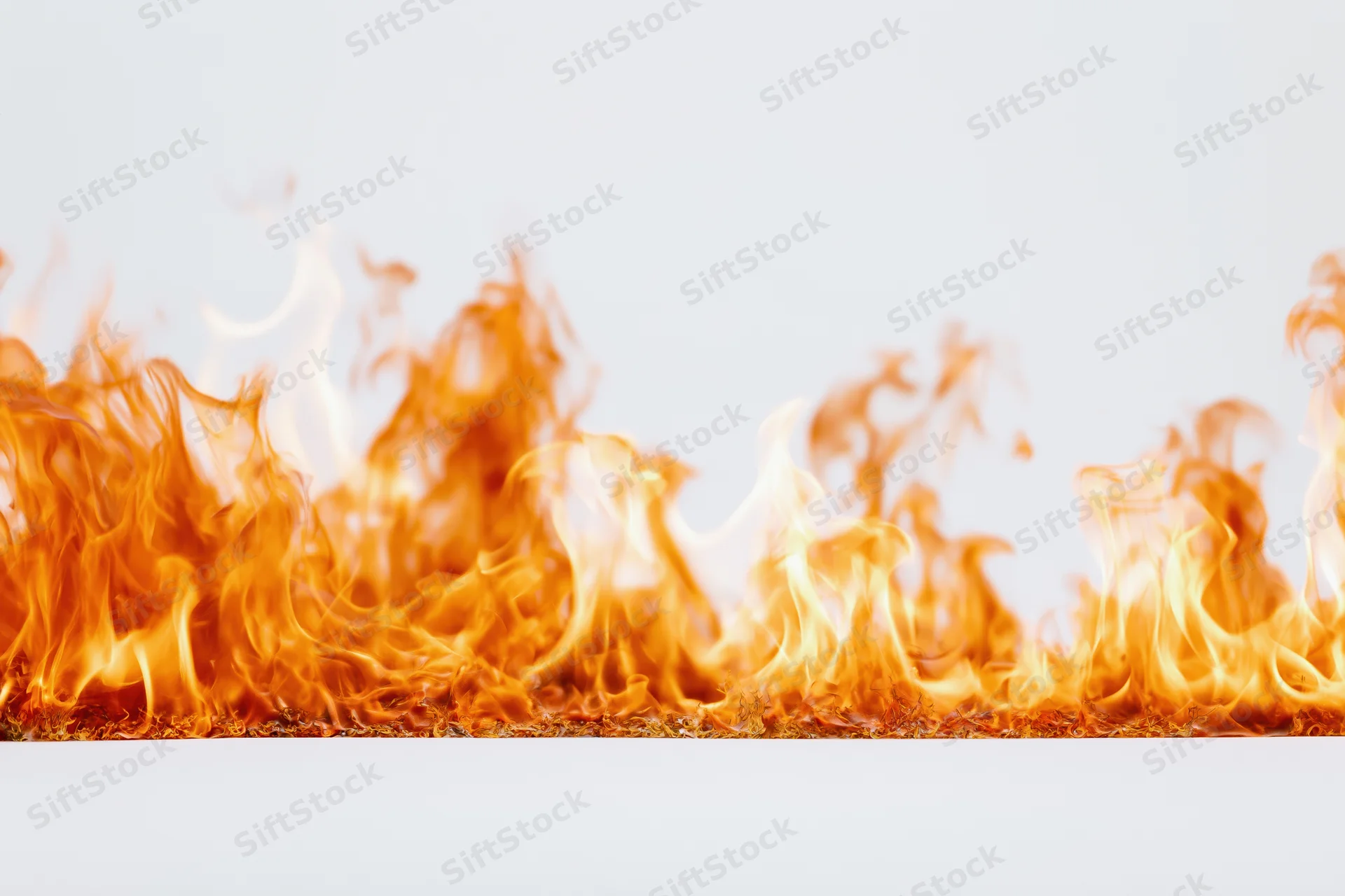 Flames burning steadily across the bottom of a white background with copyspace above
