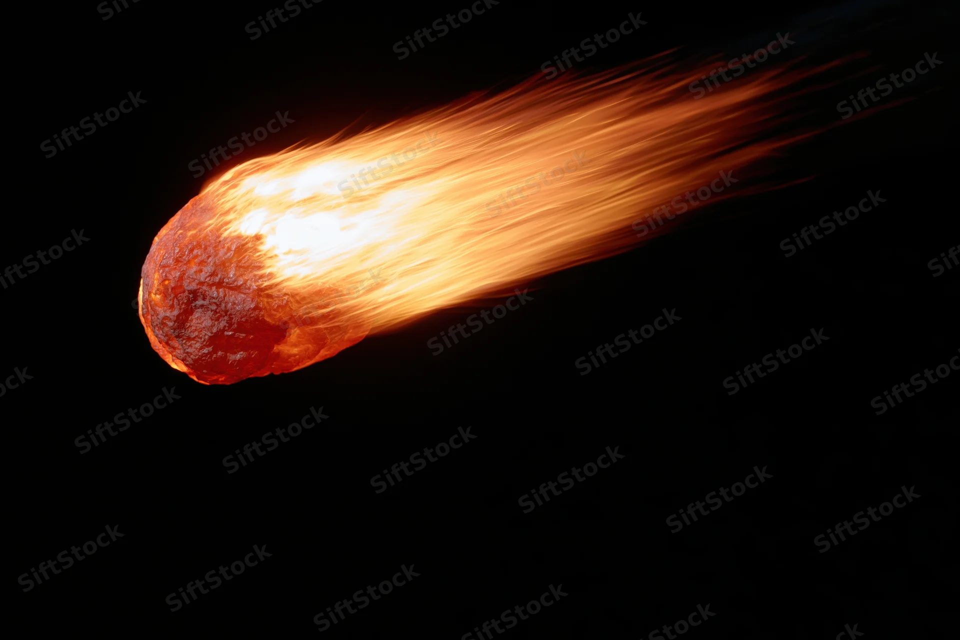 Glowing meteor streaking through dark space with fiery trail