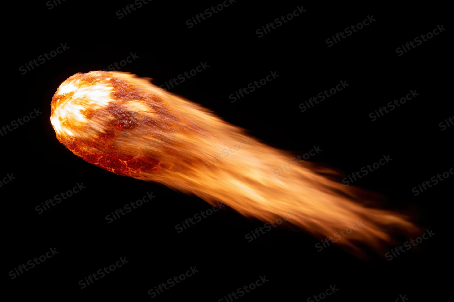 Glowing fireball with trailing flame streaks moving diagonally across black background