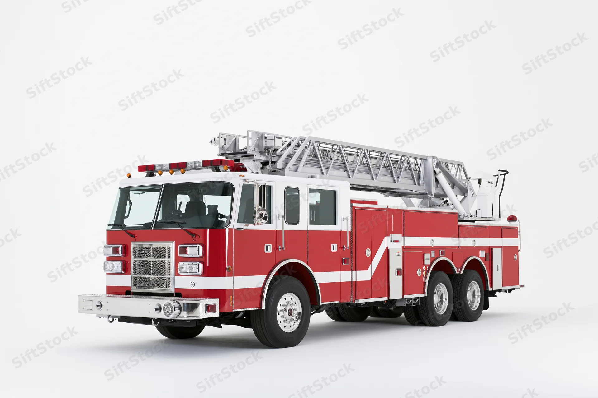 Red and white american ladder fire truck parked stationary on white background