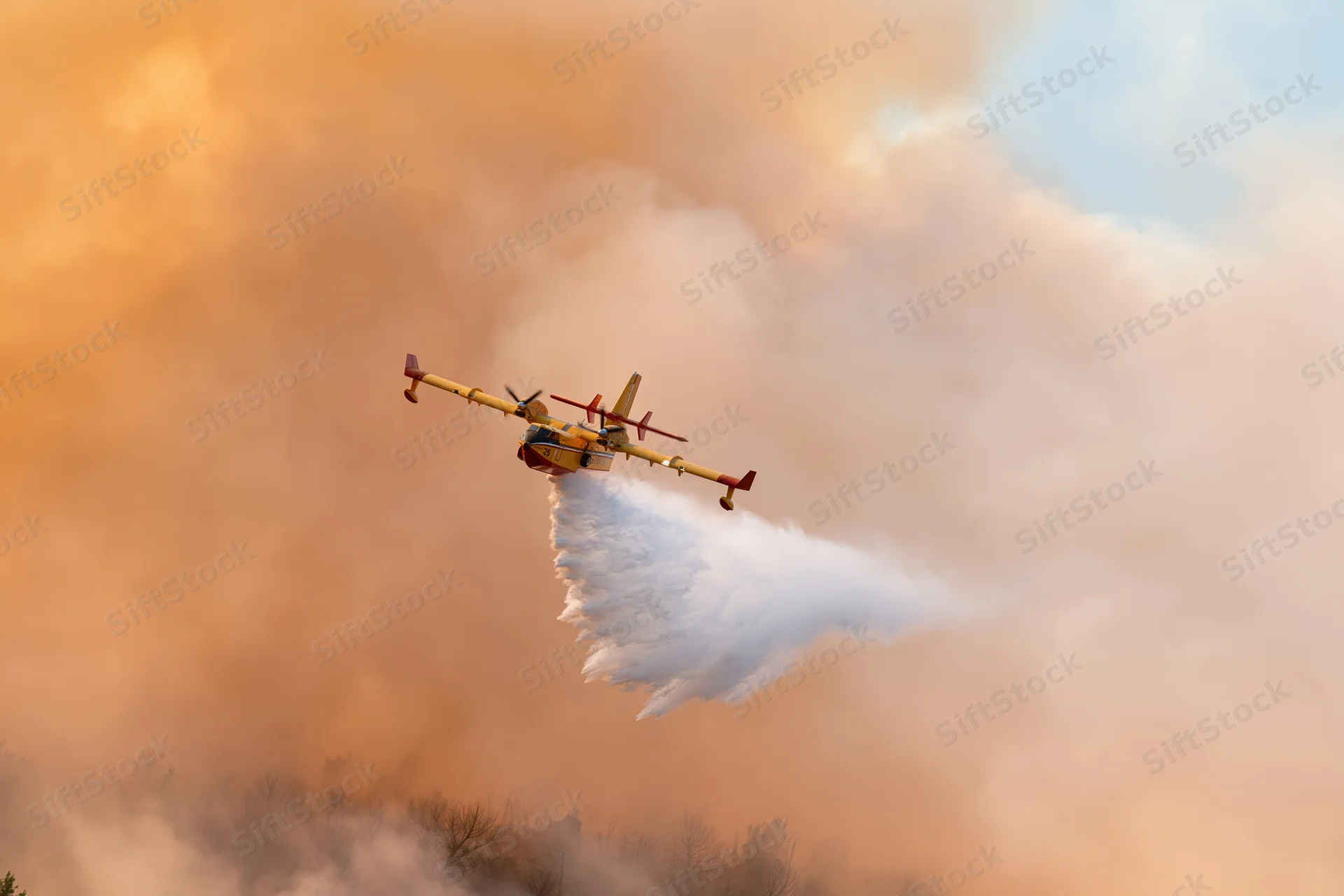 Canadair cl415 aircraft releasing water over smoky forest landscape