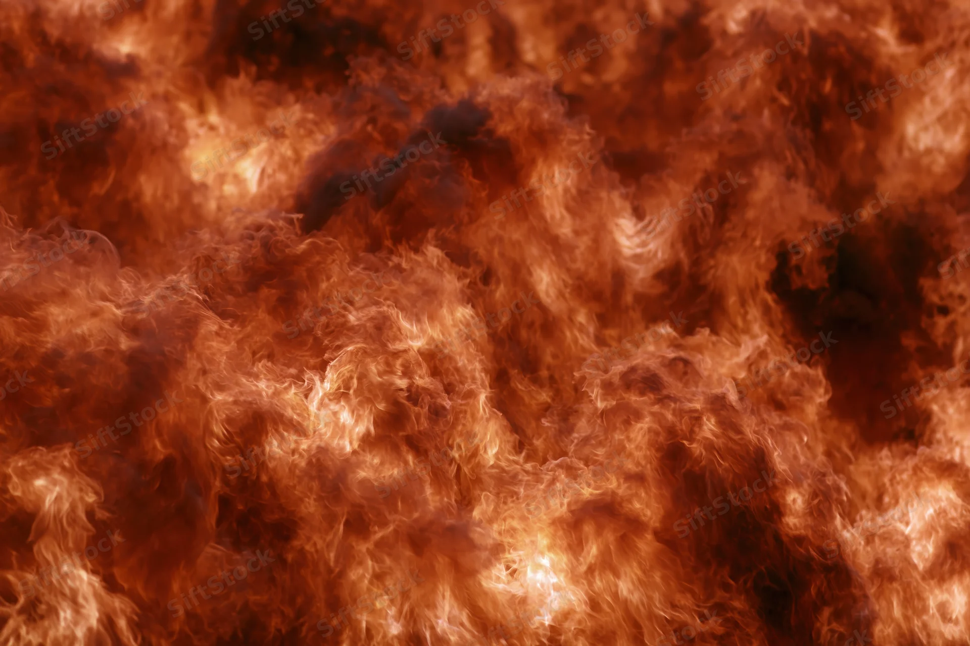 Close-up of roaring flames filling the frame with swirling fire and smoke