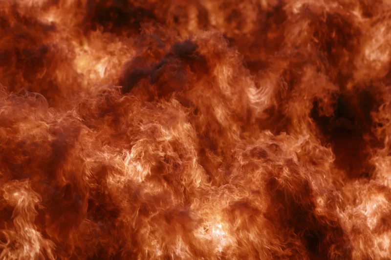 Close-up of roaring flames filling the frame with swirling fire and smoke