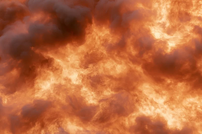 Roaring fire engulfing the entire frame with intense orange and red flames and billowing smoke