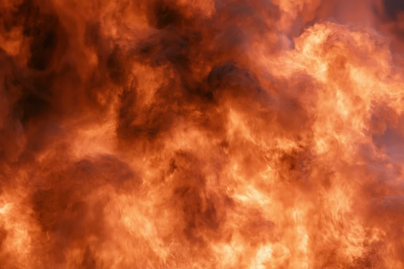 Roaring fire engulfing the entire frame in intense flames and smoke
