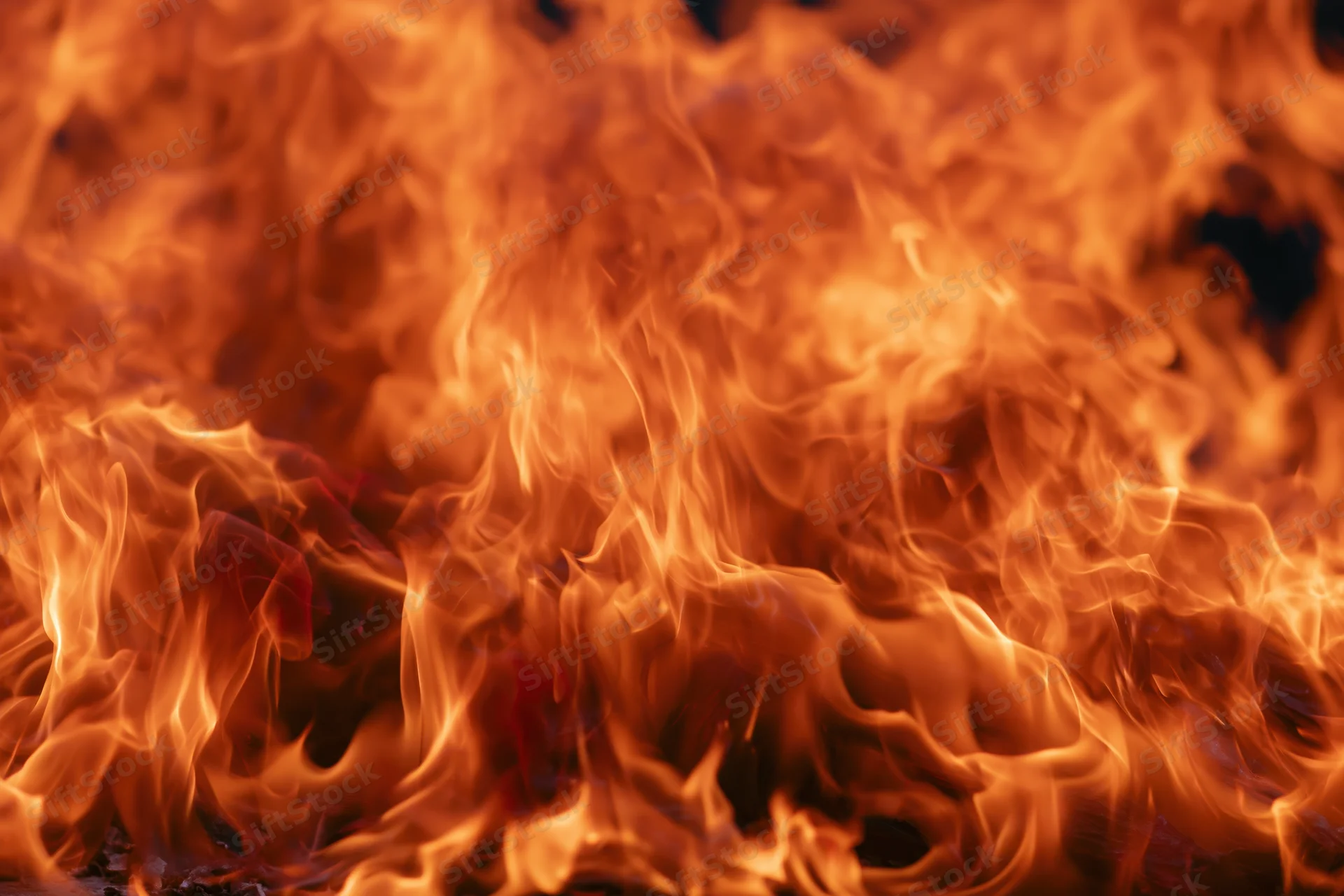 Intense flames filling the frame with swirling orange and red fire