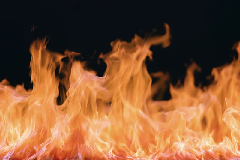 Tall flames rising against a pure black background