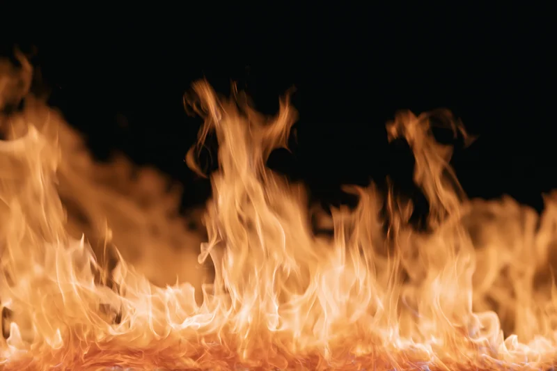 Tall flames rising against a pure black background