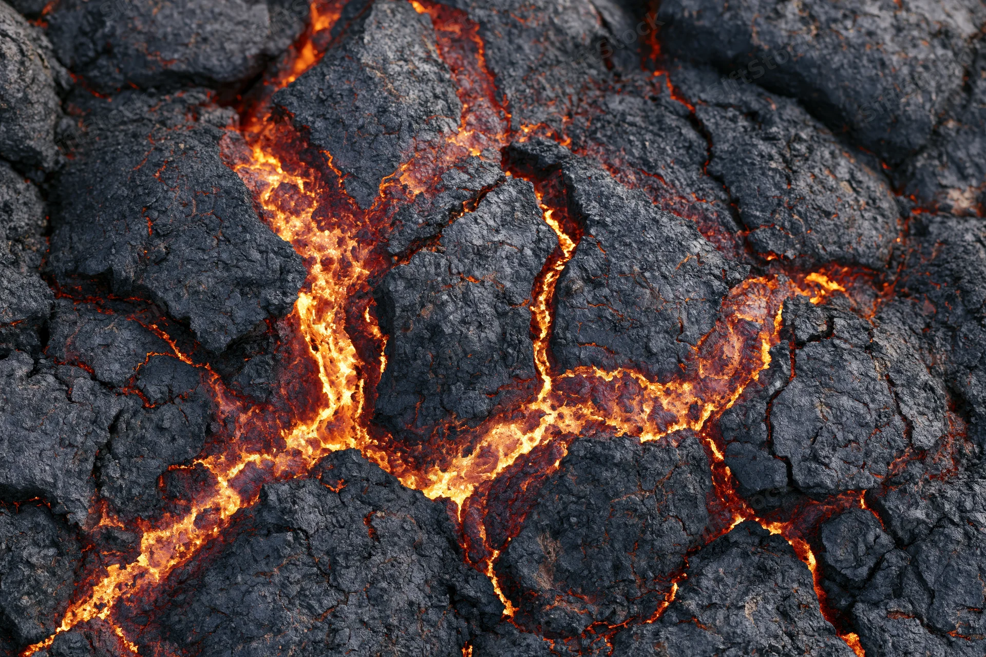 Close-up of cooling volcanic lava crust with glowing cracks and dark rock surface