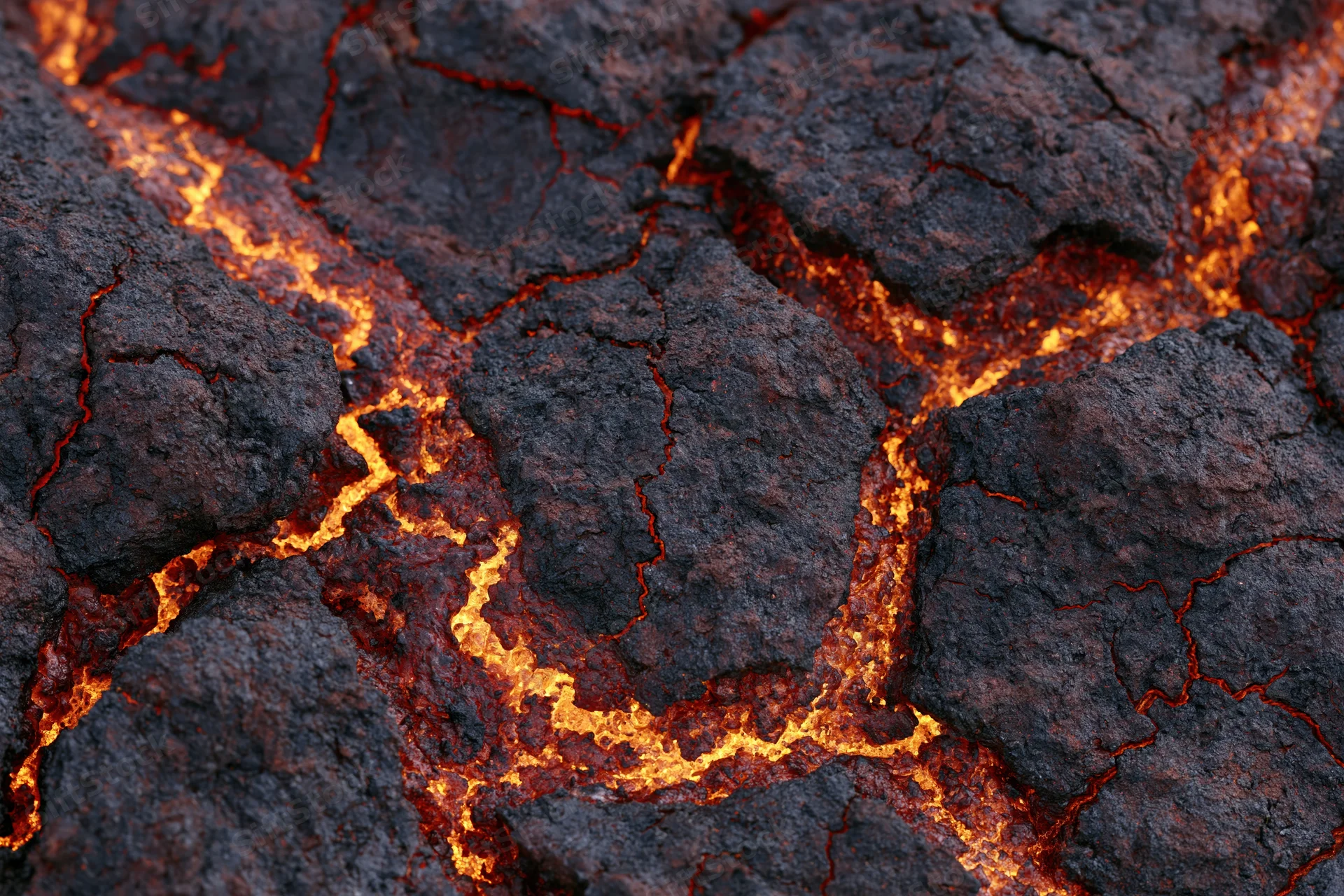 Close-up of cooling volcanic lava crust with glowing cracks and dark surface