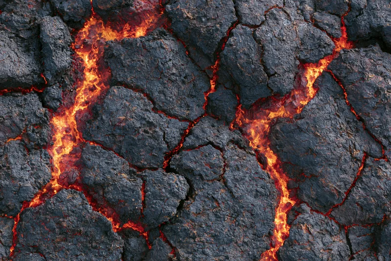 Cooling volcanic lava crust with glowing cracks and dark rock surface
