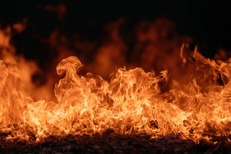 Roaring flames filling the frame against a dark background