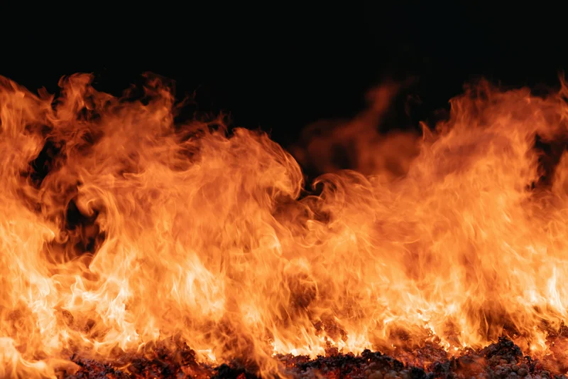 Roaring flames filling the frame against a dark background