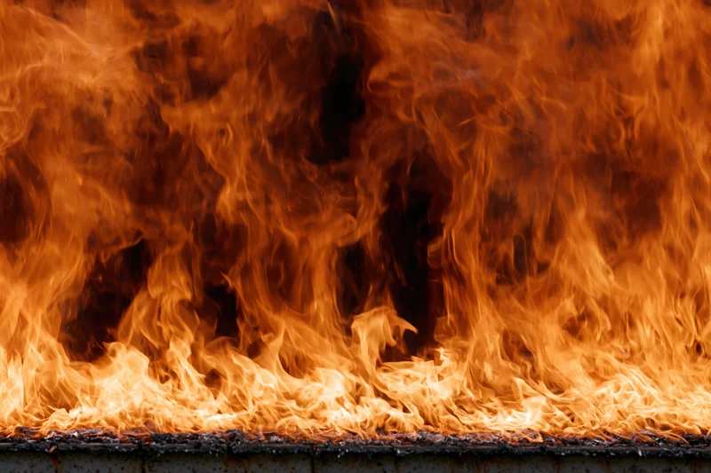 Roaring flames filling the frame with intense heat and smoke