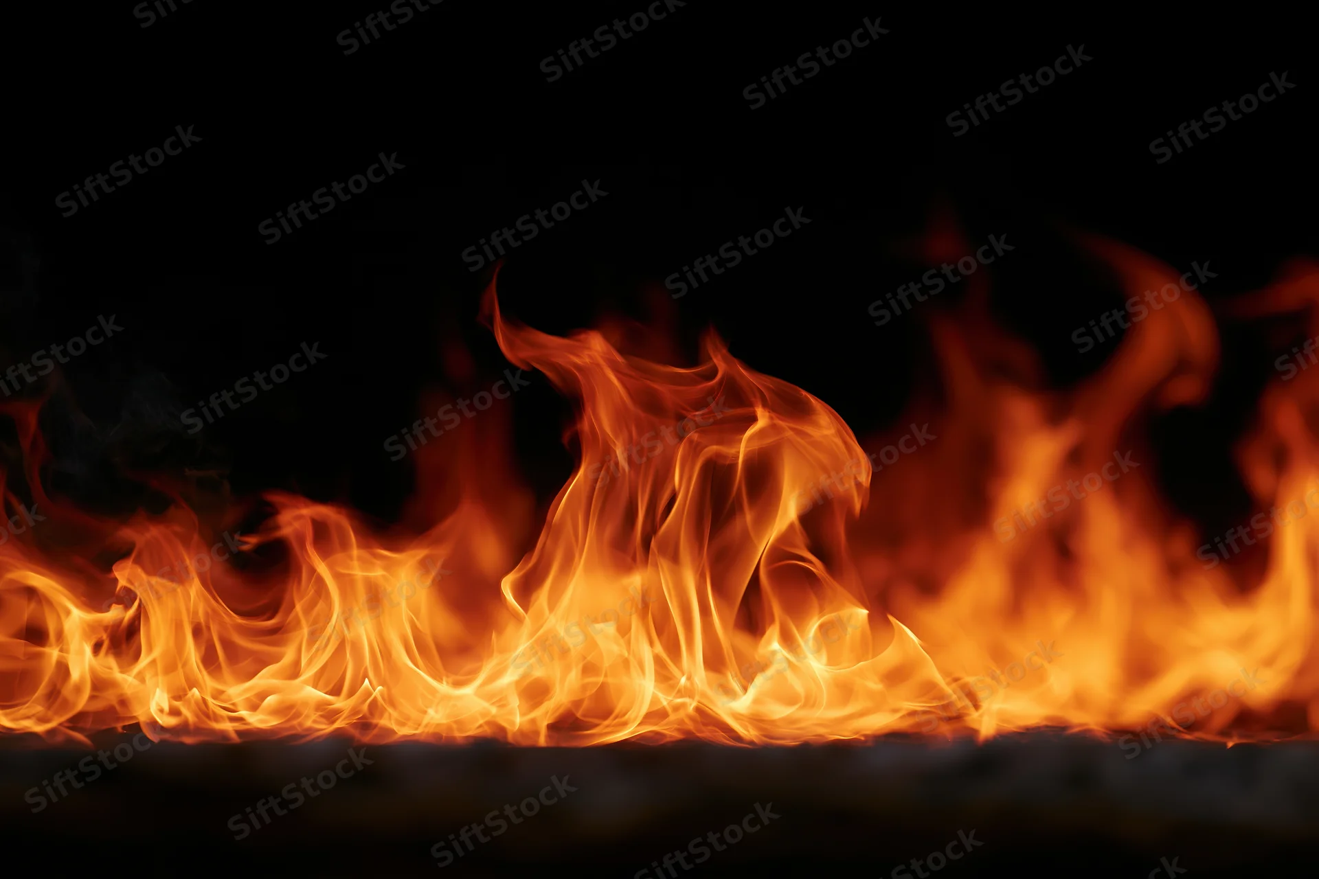 Flames spreading horizontally across dark background