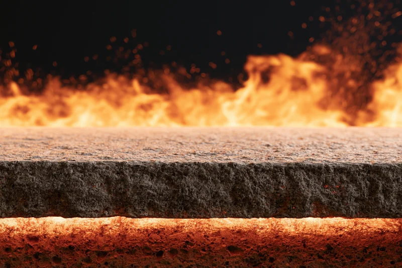Concrete ledge with flames and sparks in the background