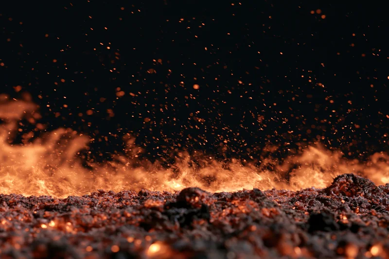 Flames and glowing embers burning along the bottom edge against a dark background