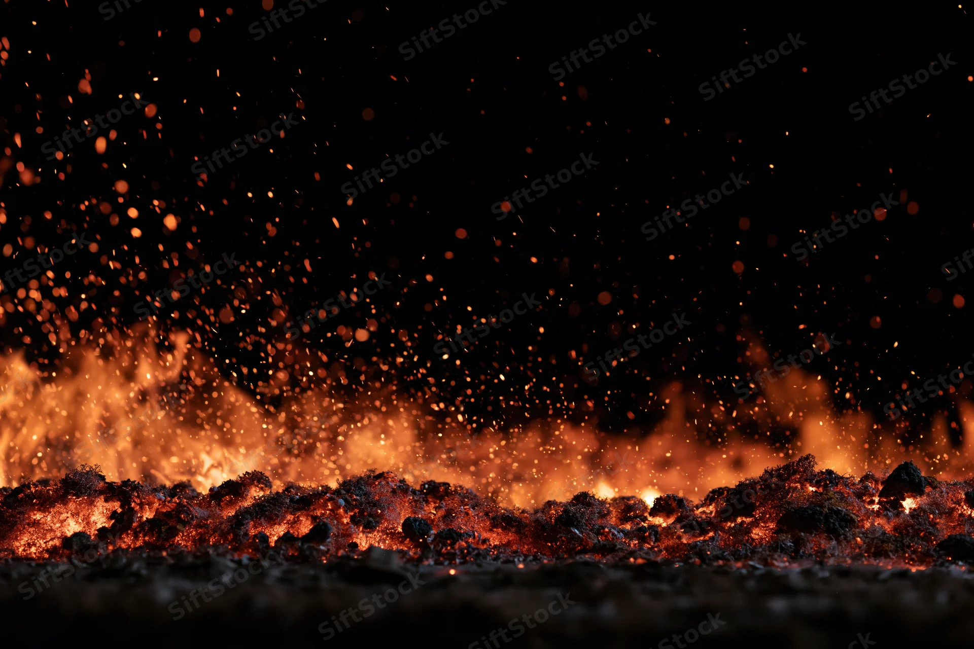 Fire flames and glowing embers burning along the bottom edge against a dark background
