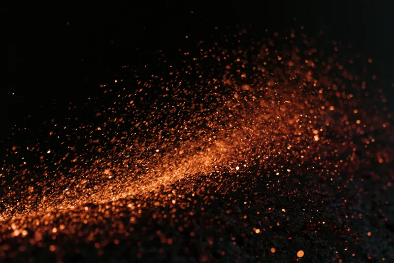 Glowing orange sparks flying through dark space with motion blur and bokeh effect