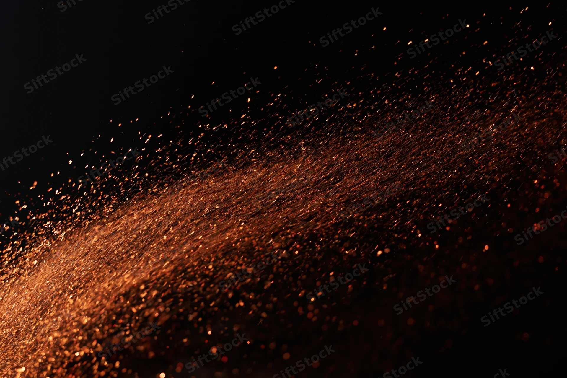 Glowing sparks flying through dark space in dynamic motion