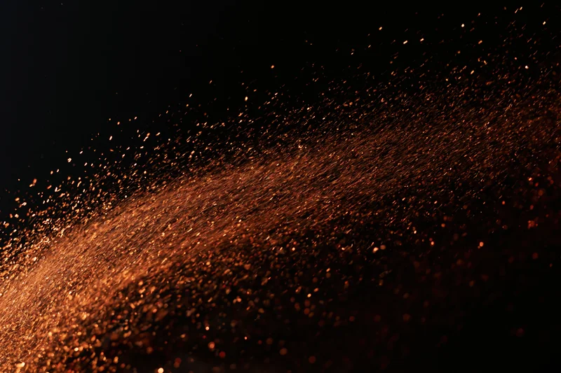 Glowing sparks flying through dark space in dynamic motion