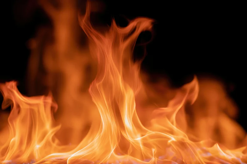 Intense flames burning brightly against a black background
