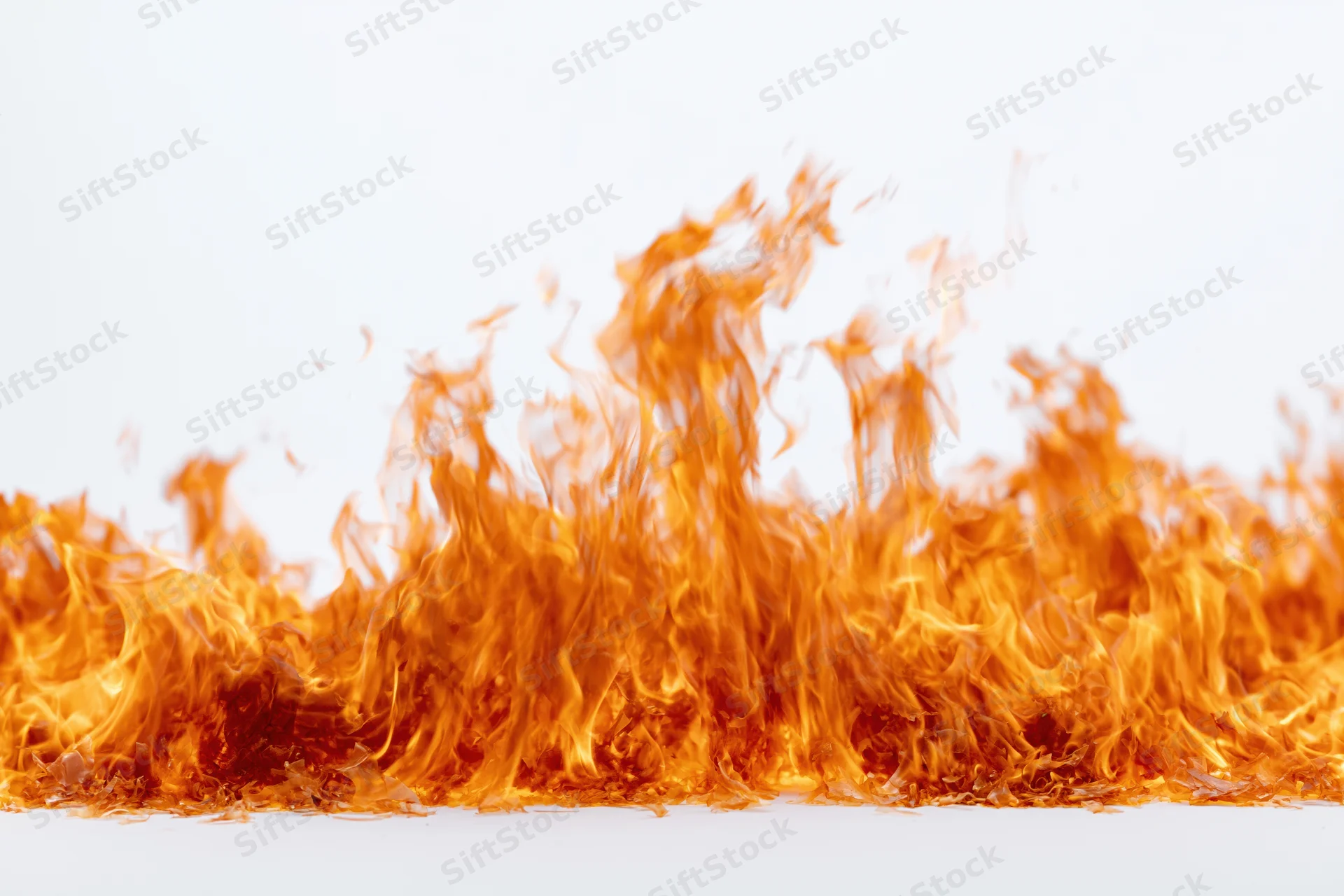 Fire flames burning upward against a pure white background