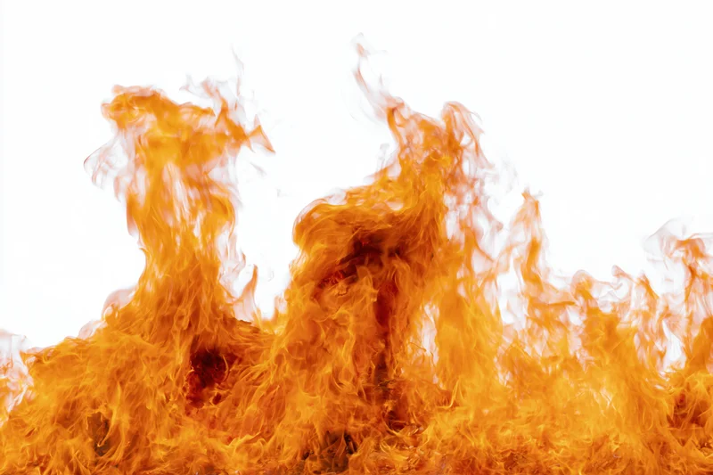 Fire flames burning upward against a pure white background