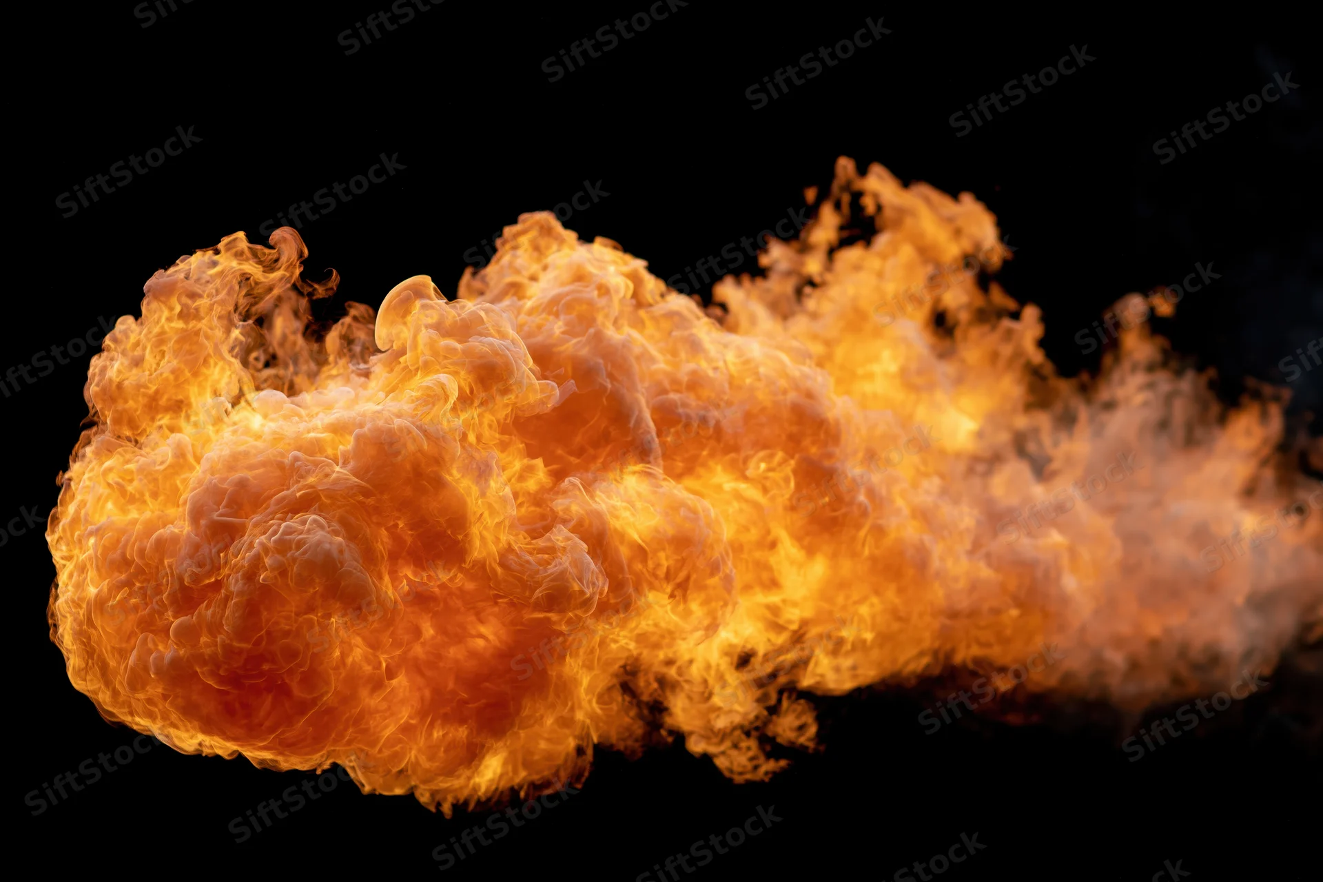 Large burst of open flame spreading horizontally against a black background