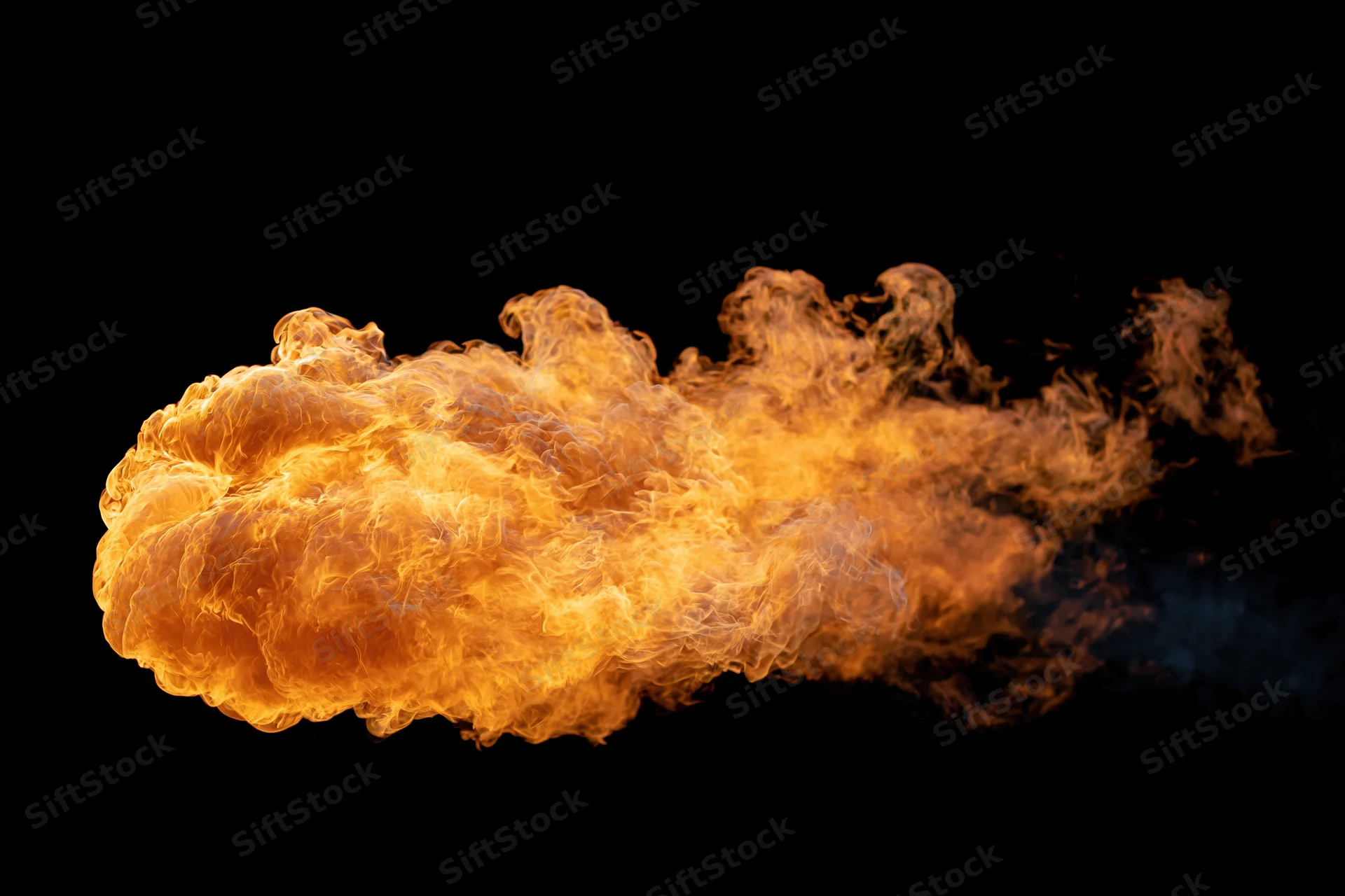 Large burst of open flame spreading horizontally against a black background