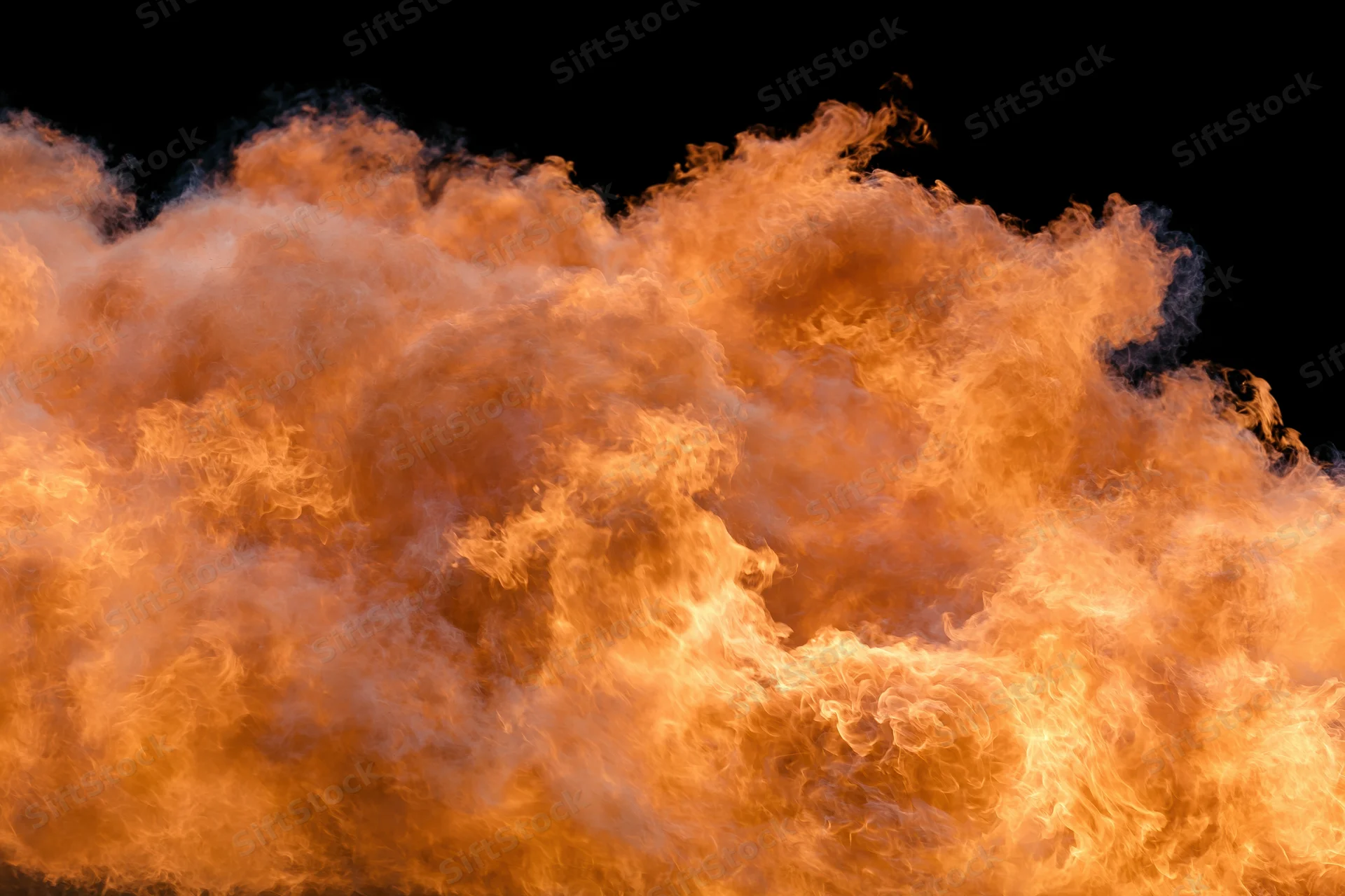 Large burst of open flames spreading horizontally against black background