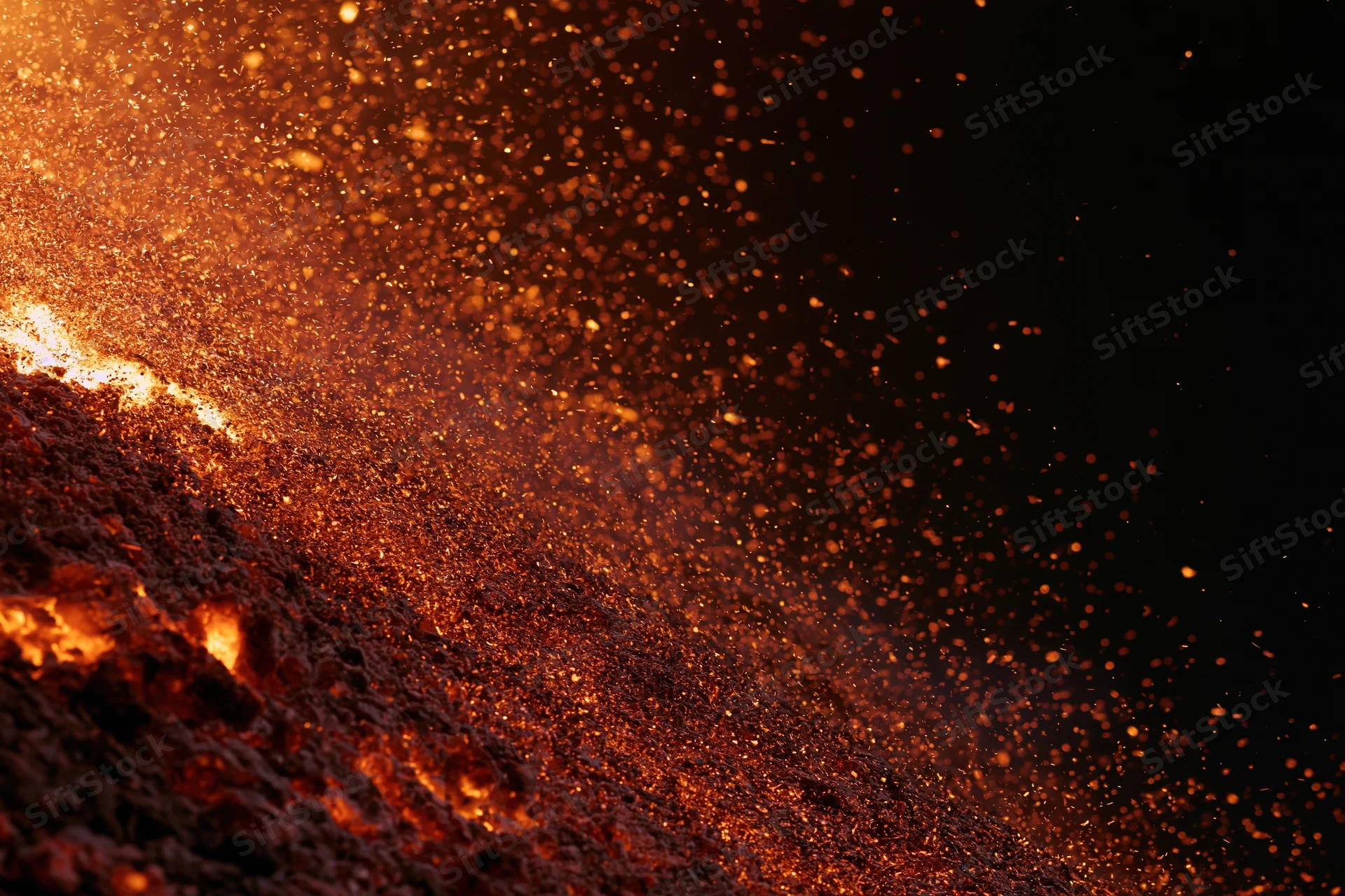 Intense fire burning with flying sparks against a black background