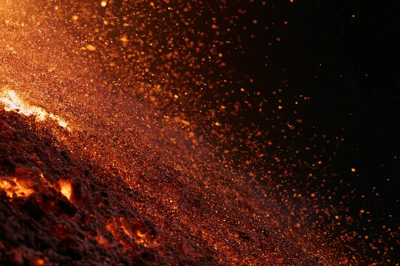 Intense fire burning with flying sparks against a black background