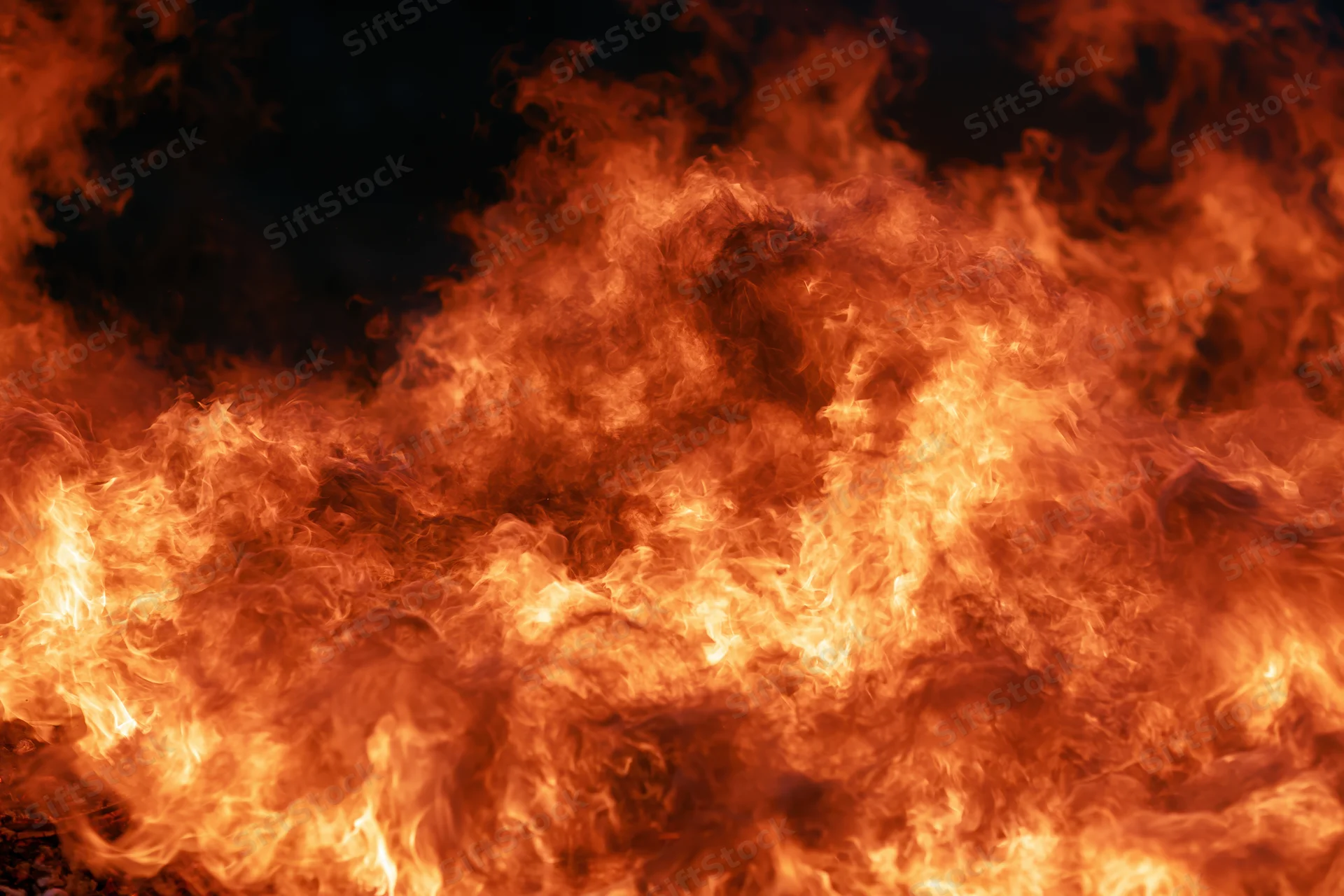Intense flames burning at night in extreme close-up view
