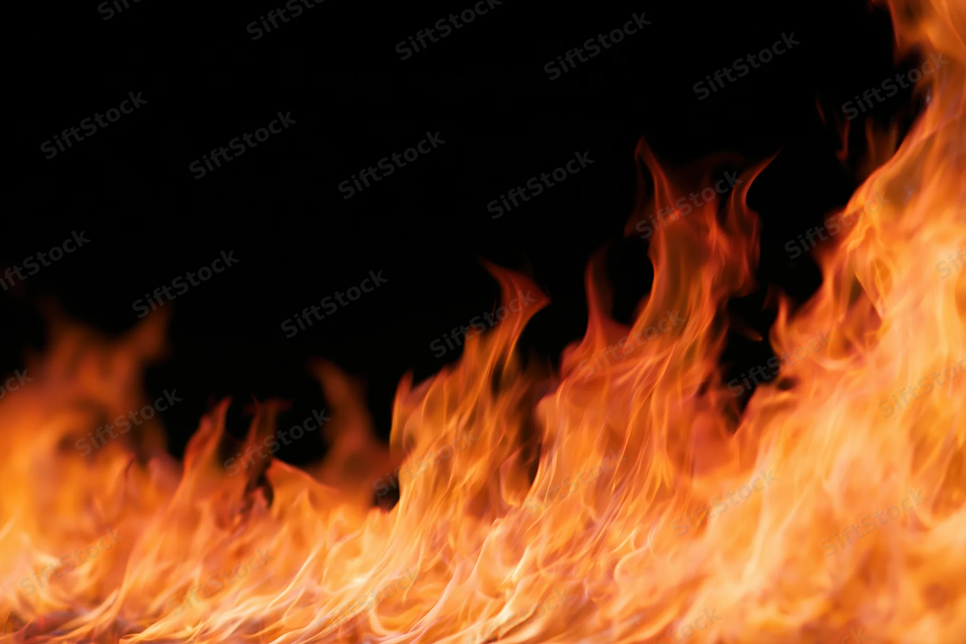 Intense flames burning across the bottom and right side against a black background