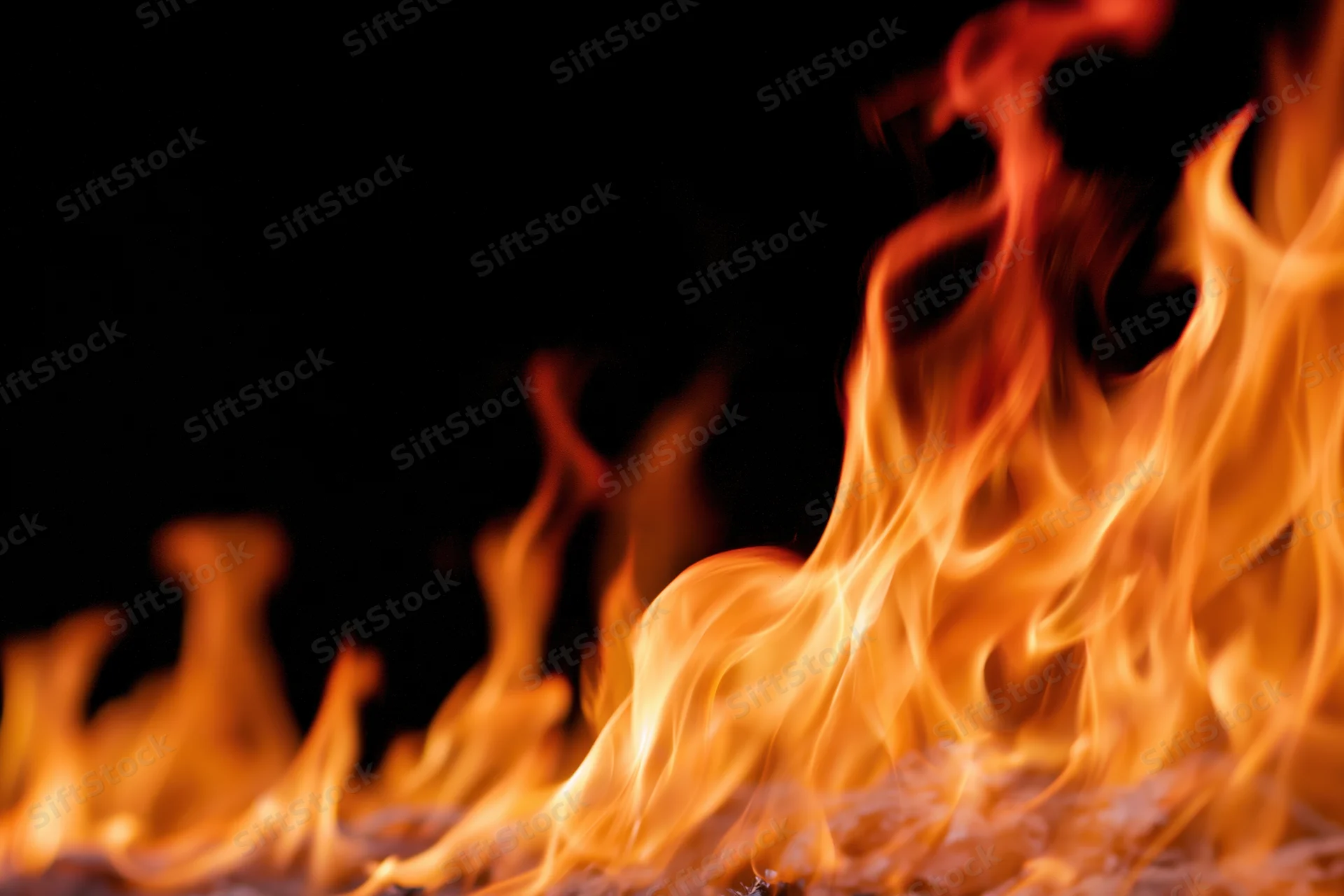 Intense flames burning along the bottom and right side against a dark background