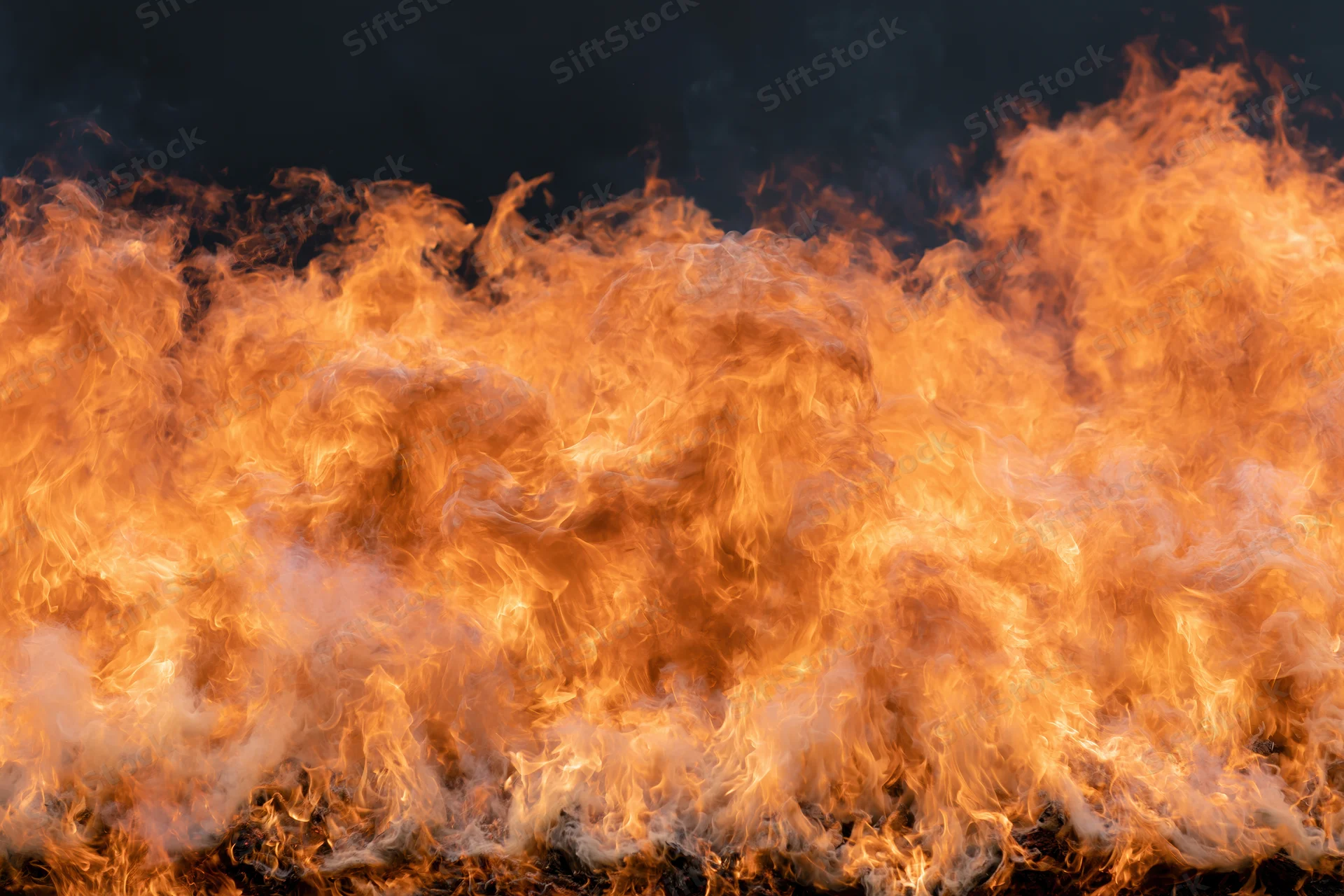 Large wall of open flames filling the frame shot close