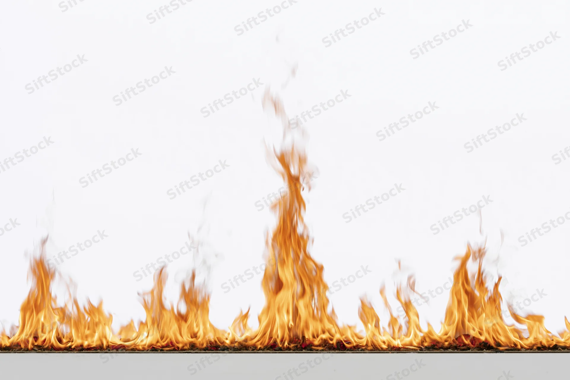 Row of flames burning along a flat surface against a white background