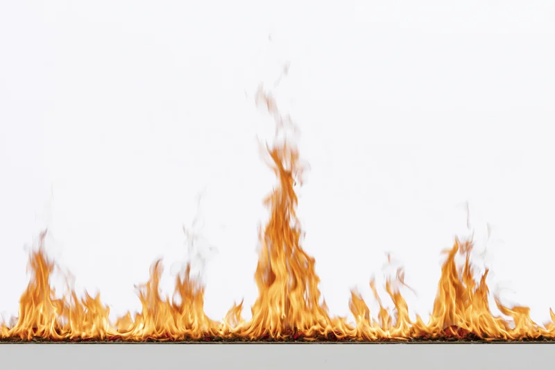 Row of flames burning along a flat surface against a white background