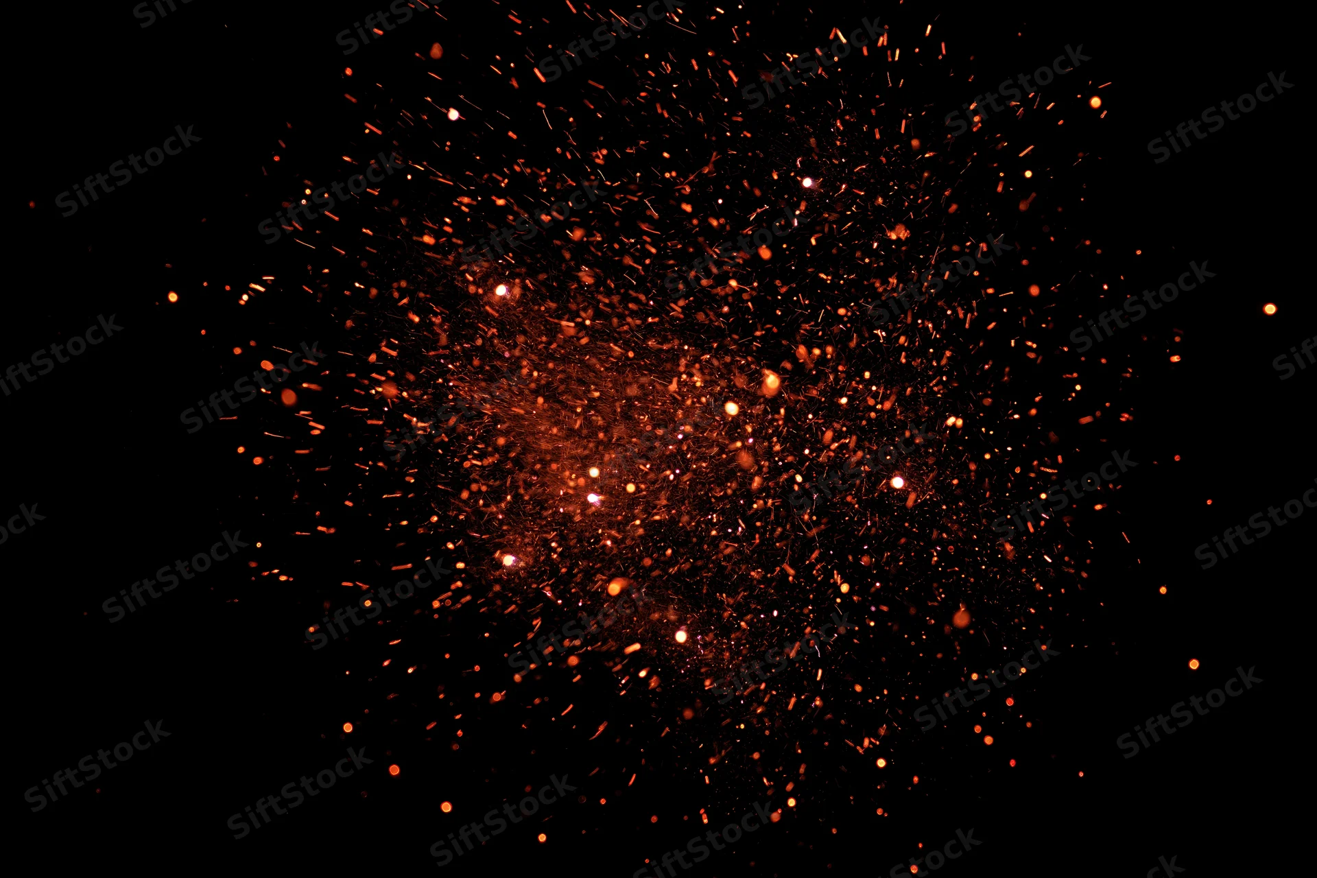 Glowing orange sparks bursting outward against a black background