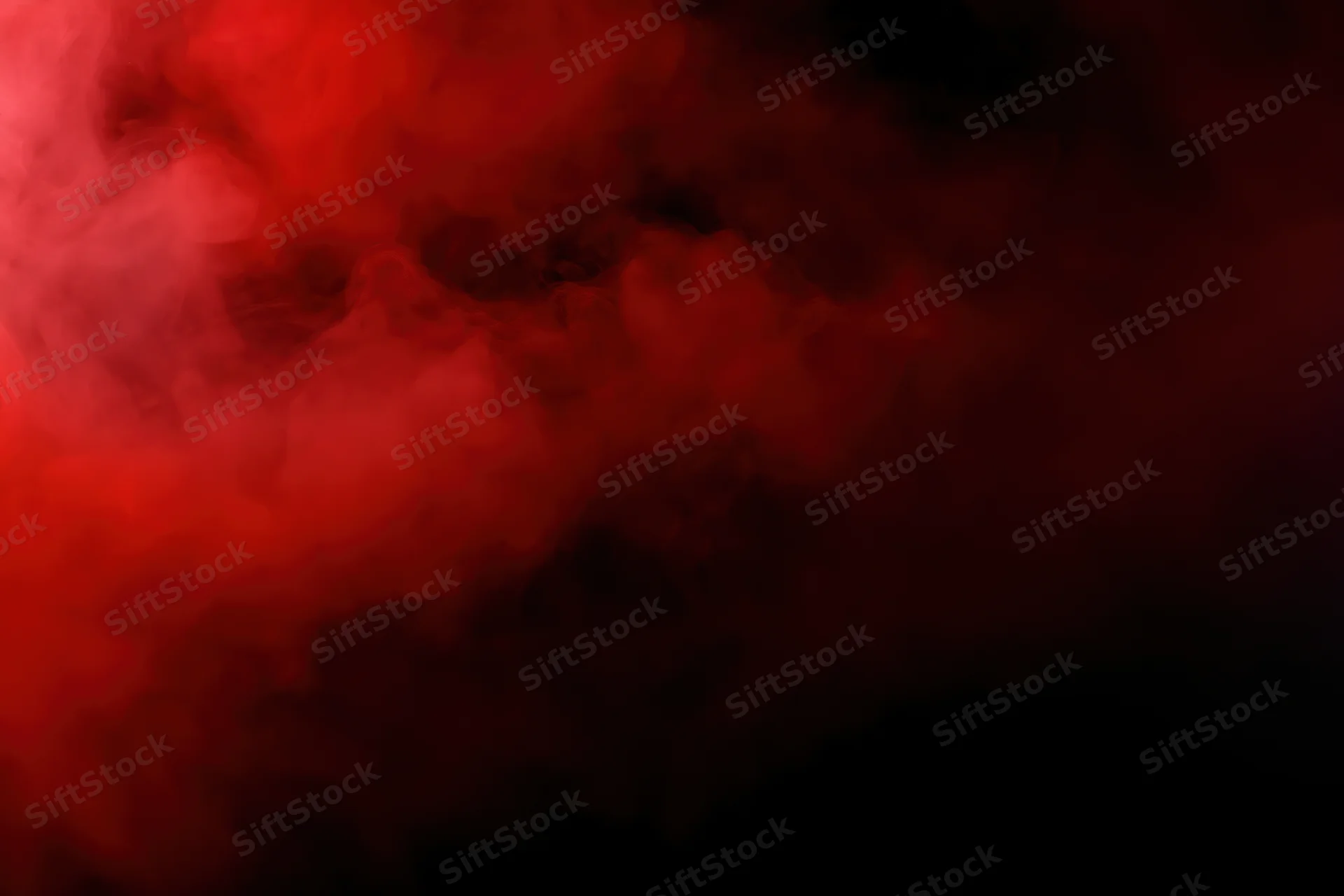 Swirling red smoke against a dark background with dramatic lighting