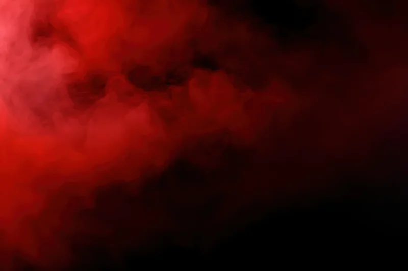 Swirling red smoke against a dark background with dramatic lighting