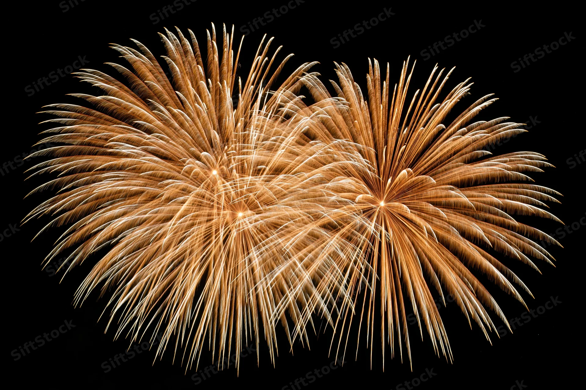Golden fireworks bursting simultaneously in the night sky