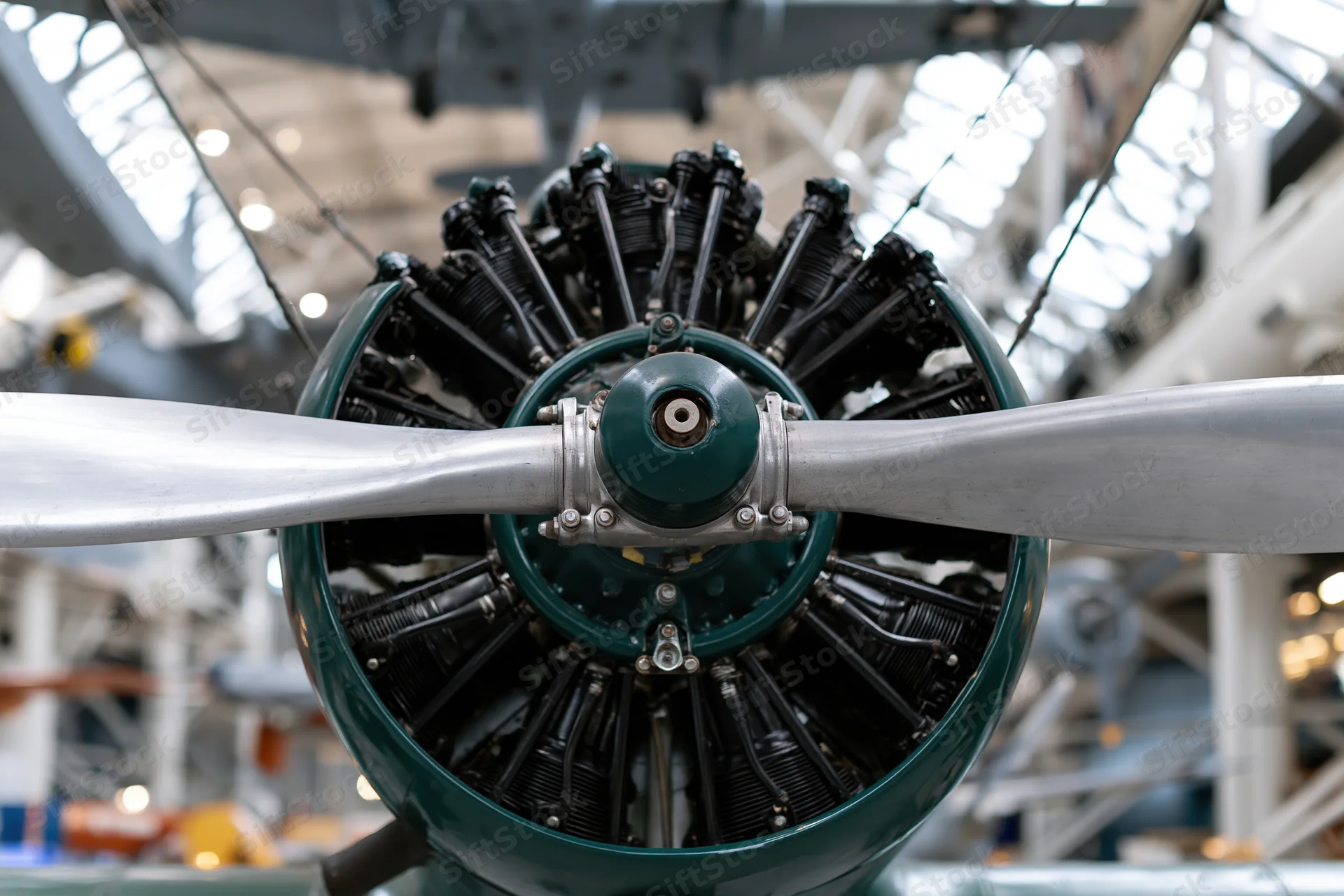Vintage radial aircraft engine with two-blade metal propeller on display in a museum