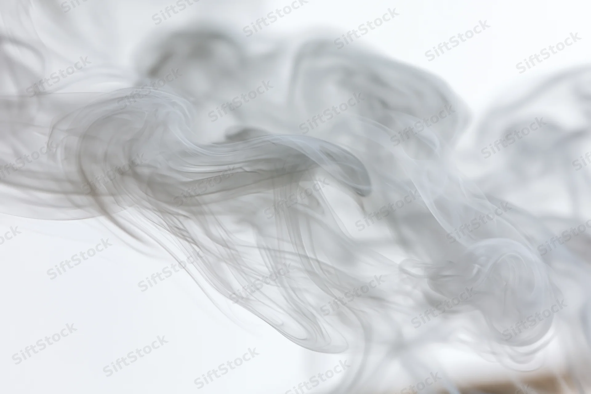 Wispy smoke curling and dispersing upward against a plain white background