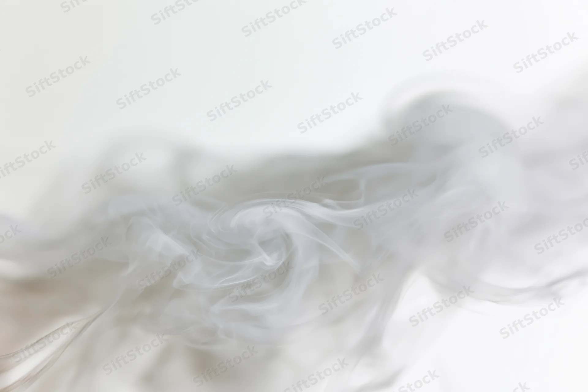 Wispy smoke curling and dispersing upward against a plain white background