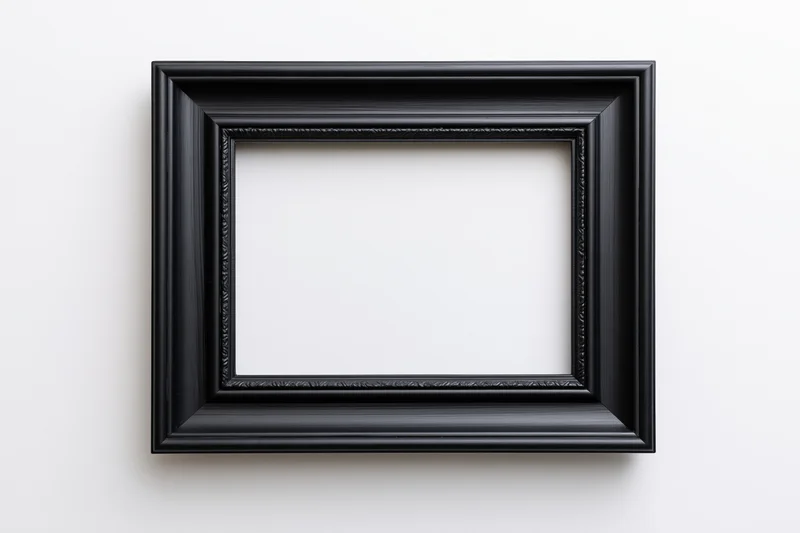 Black rectangular picture frame with molded edges hanging on white wall