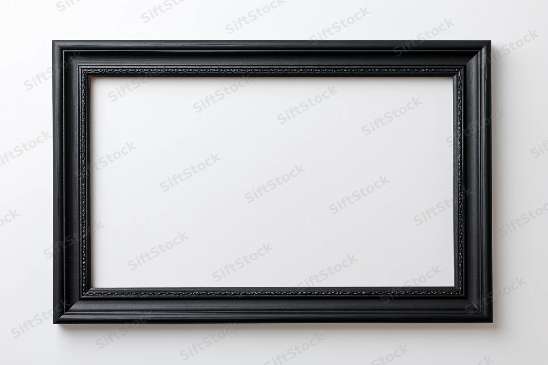 Black rectangular picture frame hanging on white wall with empty interior space