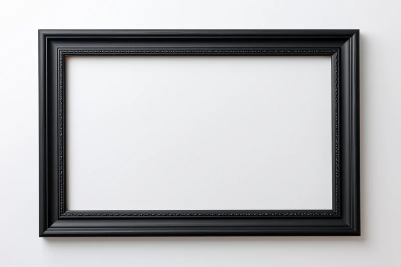 Black rectangular picture frame hanging on white wall with empty interior space